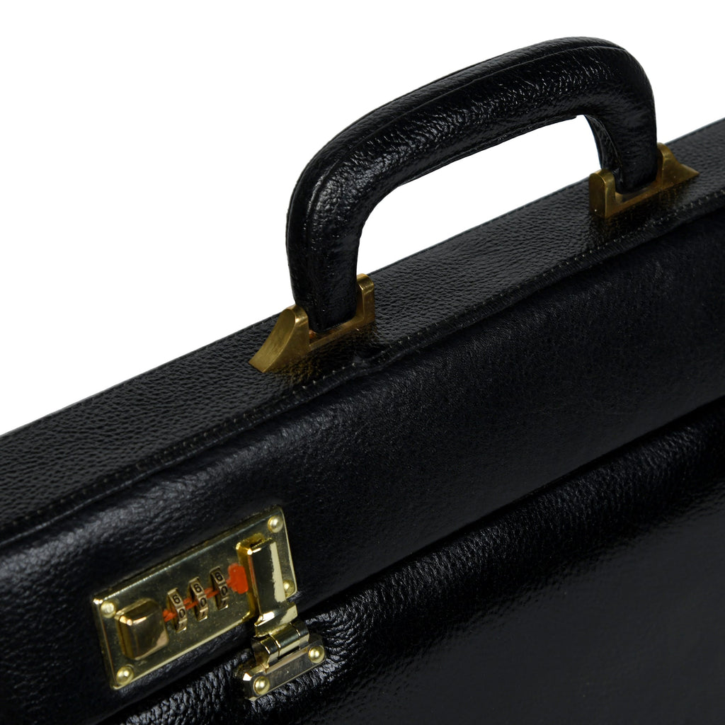 Close-up of black briefcase handle and gold-tone lock plate