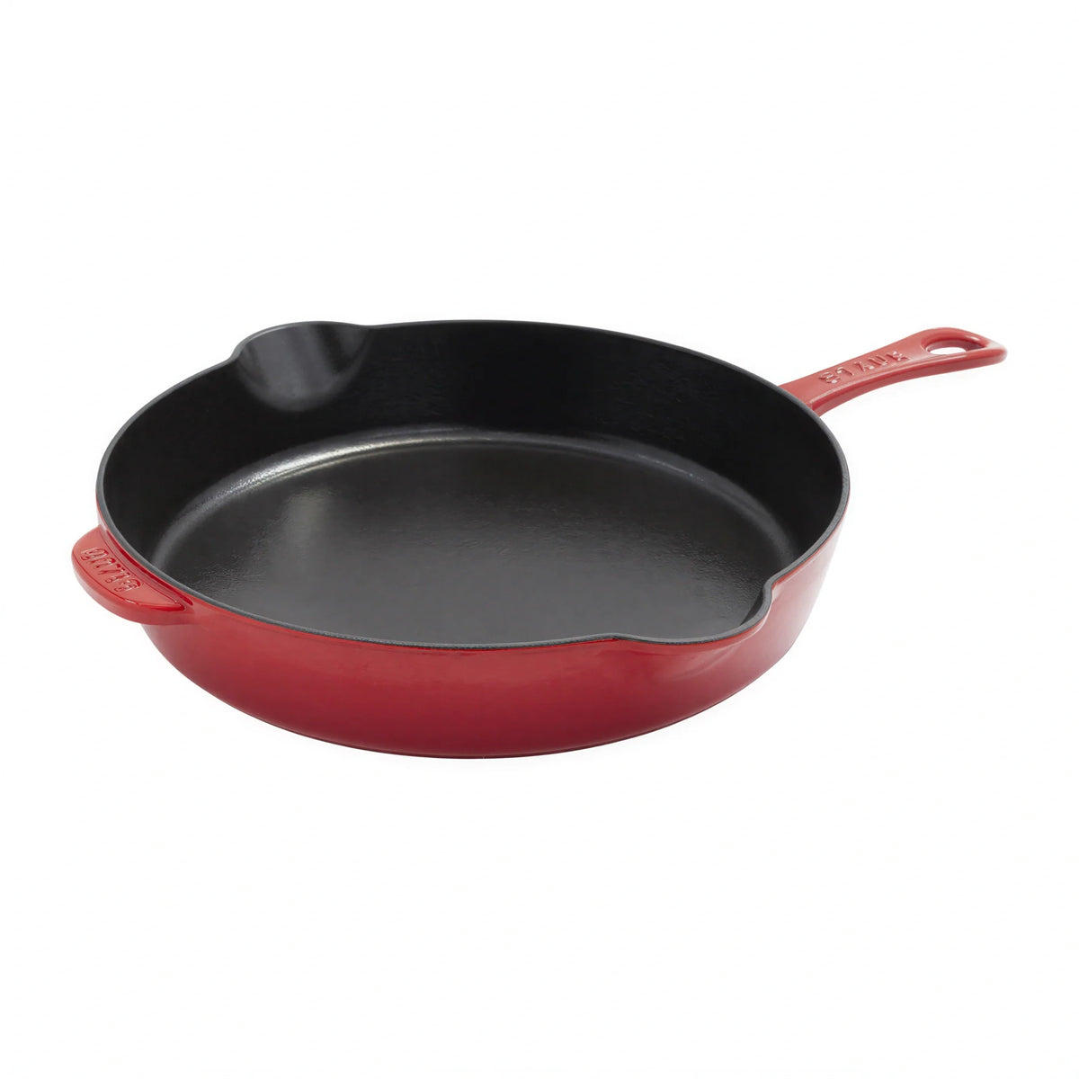 Red enameled cast iron skillet with black interior and single handle, induction ready