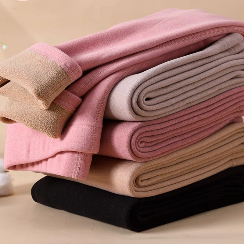 Folded cashmere leggings stack in pink, beige, brown, and dark tones, solid knit