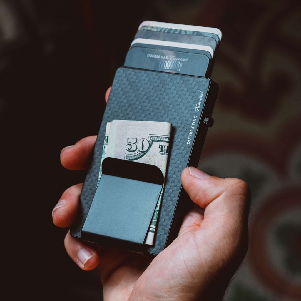 Dark blue pop-up cardholder open, showing stacked cash and card slots.