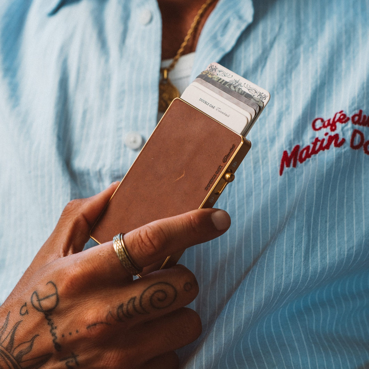 Brown leather Mod wallet with gold frame and card inserts, shown front view