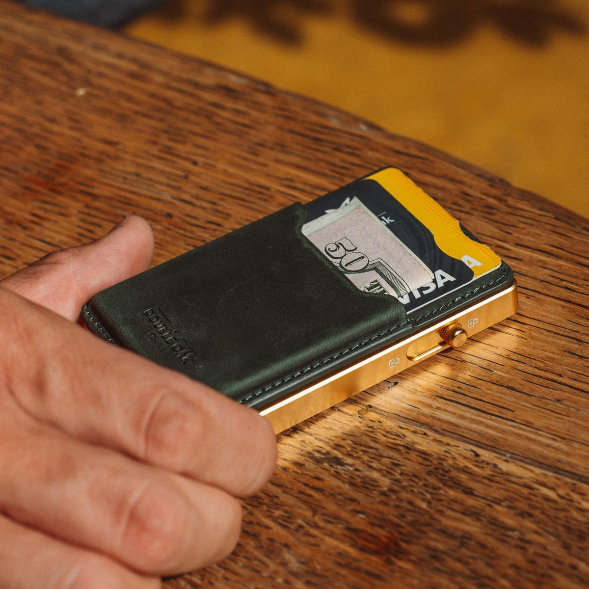 Dark green leather card mod wallet with card pocket and gold-tone hinge