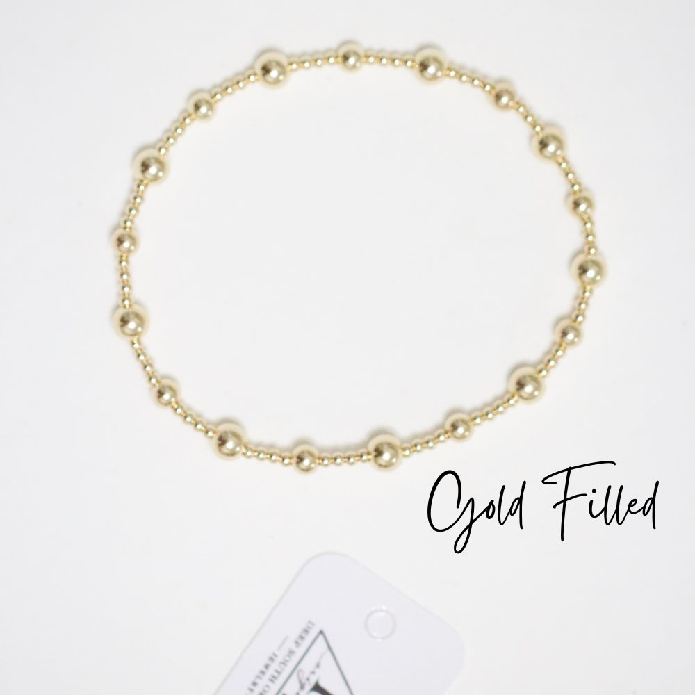 Gold-tone round-bead bracelet on a thin chain, minimalist style