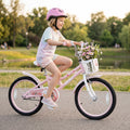 Kids 18-inch pink bike with training wheels, front basket, and child wearing helmet