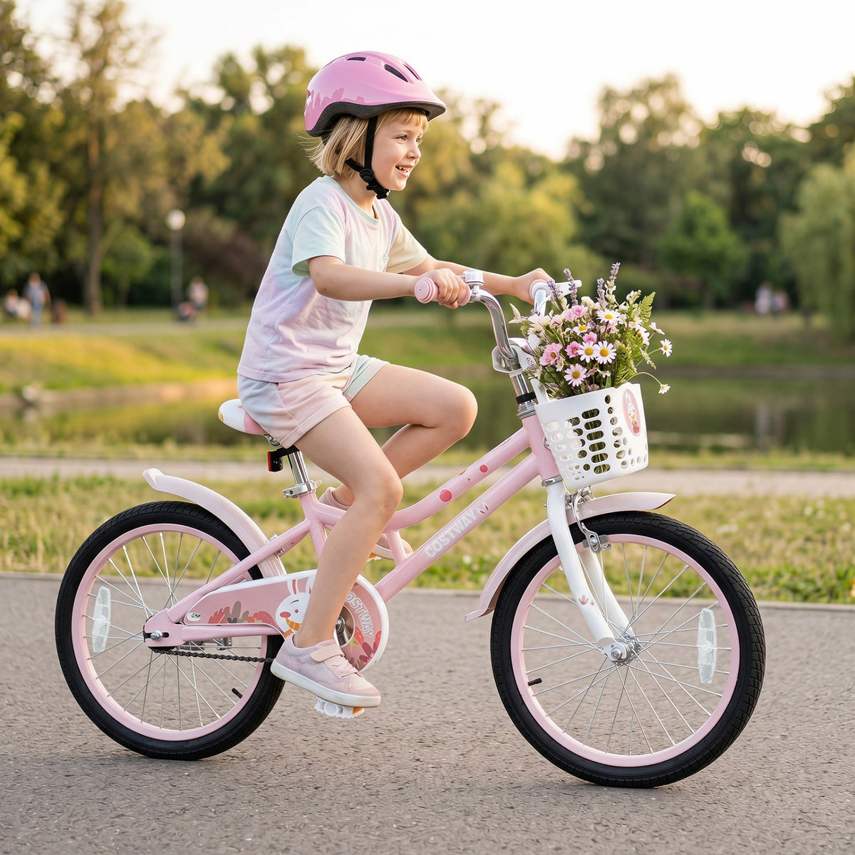 Kids 18-inch pink bike with training wheels, front basket, and child wearing helmet