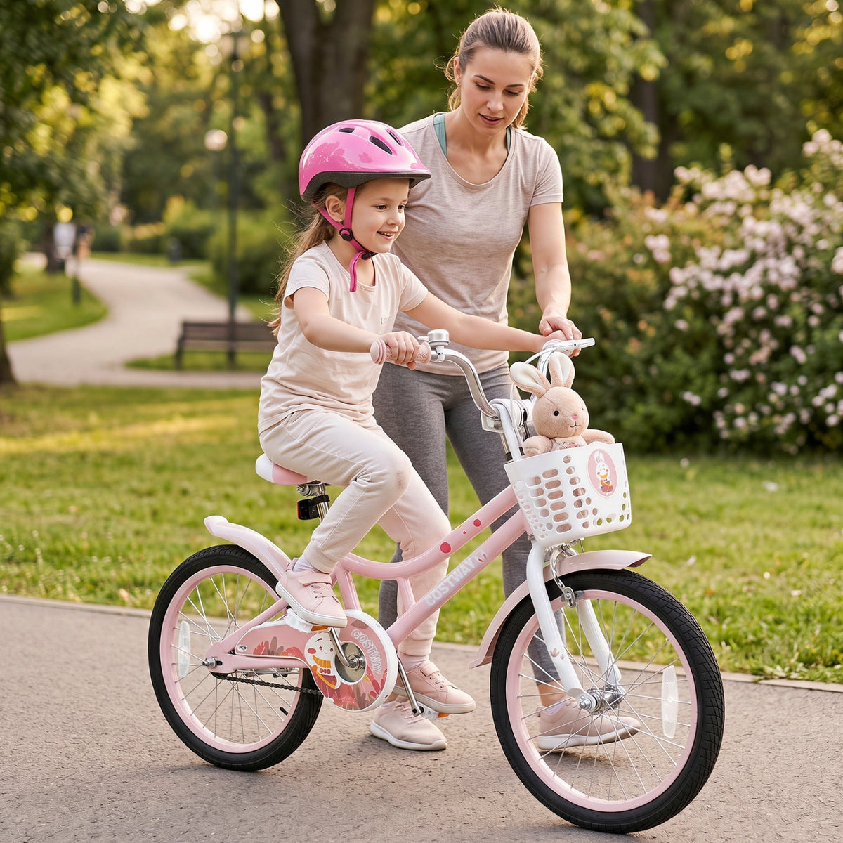 Pink 18-inch kids bike with training wheels and front basket, child riding with helmet