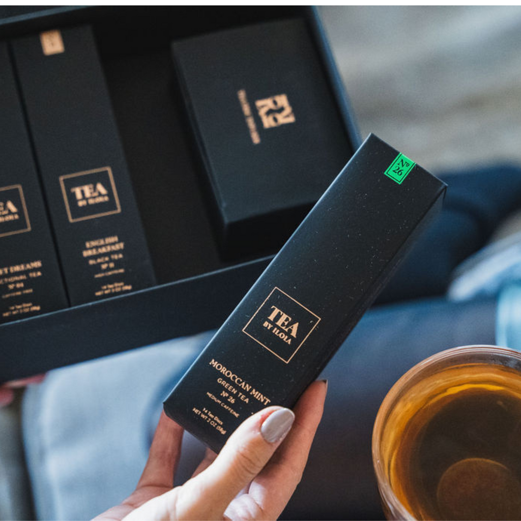 iLOLA Moroccan Mint tea box held beside a glass cup of tea