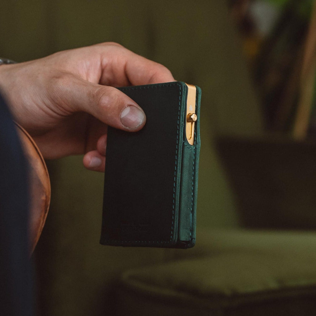 Dark green bifold wallet with contrast stitching and metal clasp detail