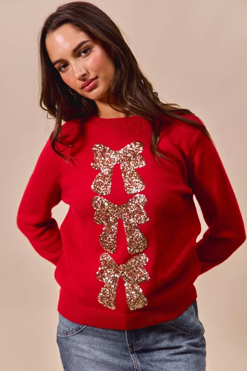 Red knit Christmas sweater with gold sequin ribbon bow and tree-like bow detail