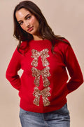 Red knit Christmas sweater with gold sequin ribbon bow and tree-like bow detail