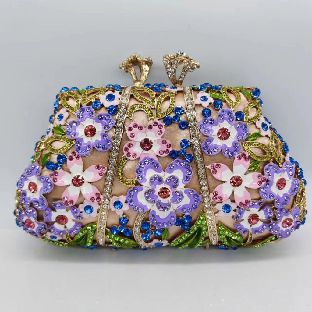 Jeweled floral evening clutch with blue rhinestones, purple enamel flowers, and decorative posts