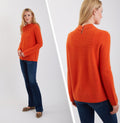 Cashmere mock neck sweater in flame orange, long sleeves with link-stitch knit detail.