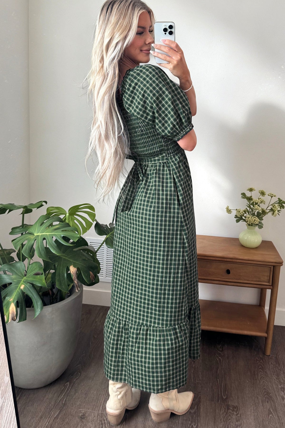 Dark green plaid dress with square neckline, shirred waist, puff sleeves, and ruffled hem.