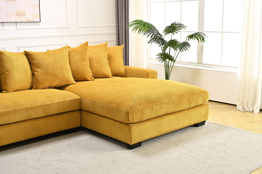 Yellow L-shaped sectional sofa with chaise corner and plush, textured cushions.