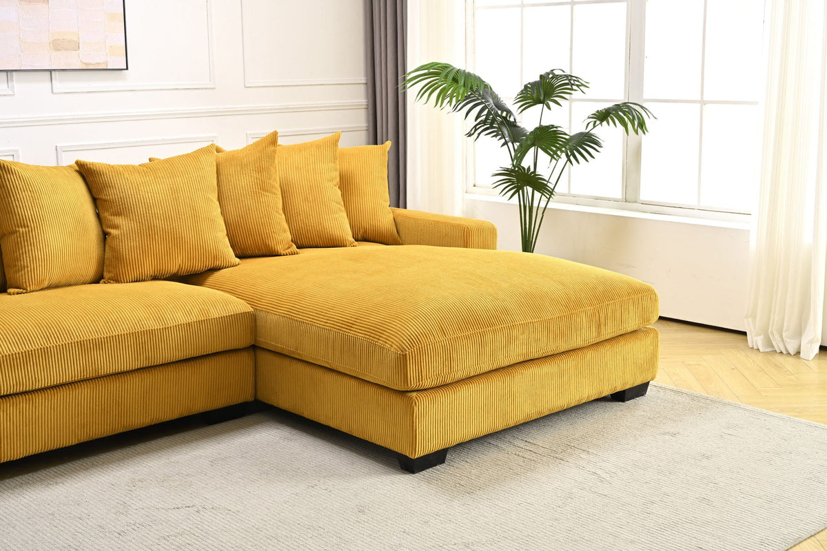 Yellow L-shaped sectional sofa with chaise corner and plush, textured cushions.