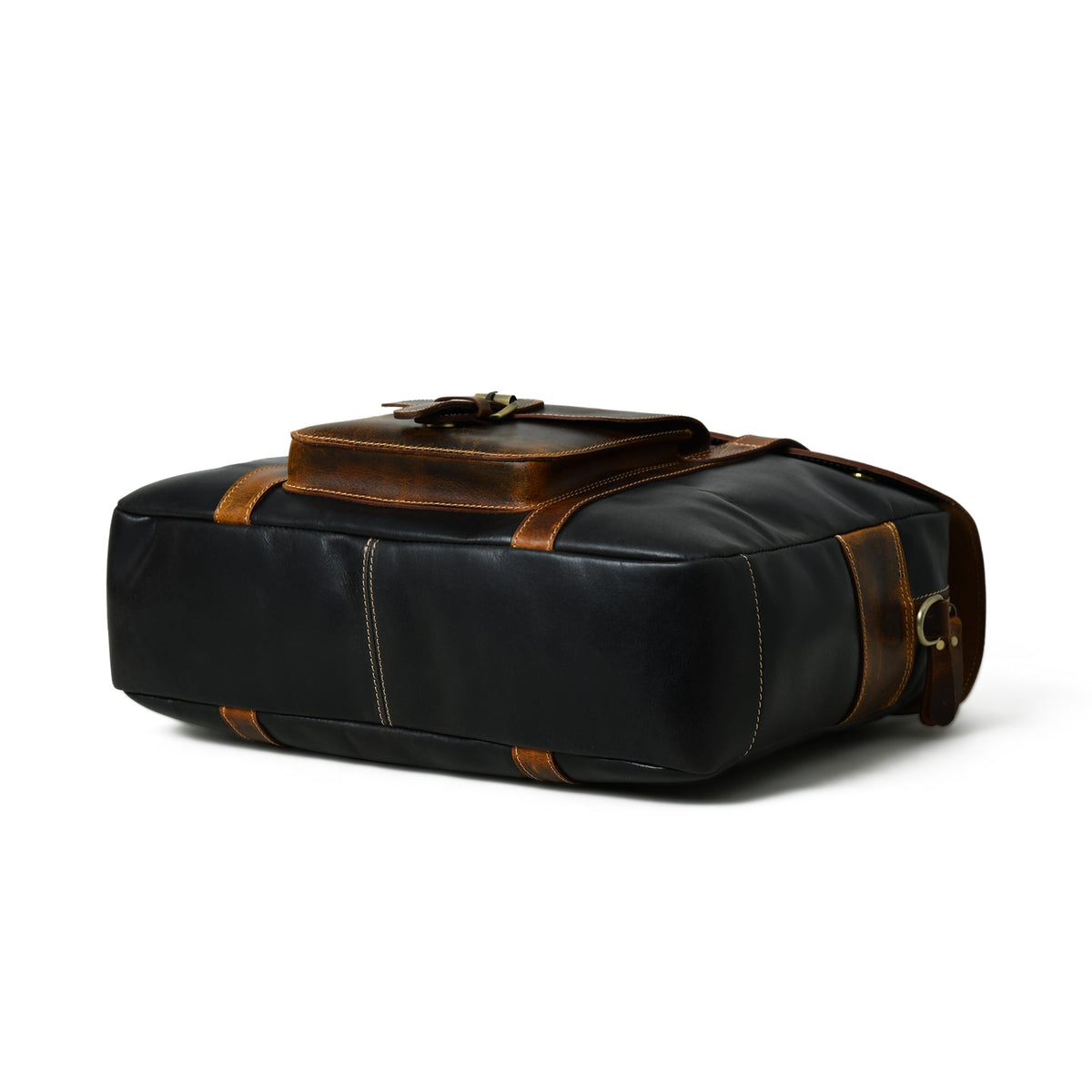 Black leather duffel-style travel bag with brown top handle, brass clips, and side straps
