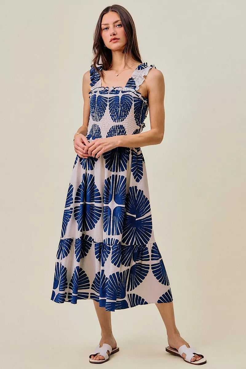 Navy and white abstract print midi dress with smocked bodice and tiered skirt