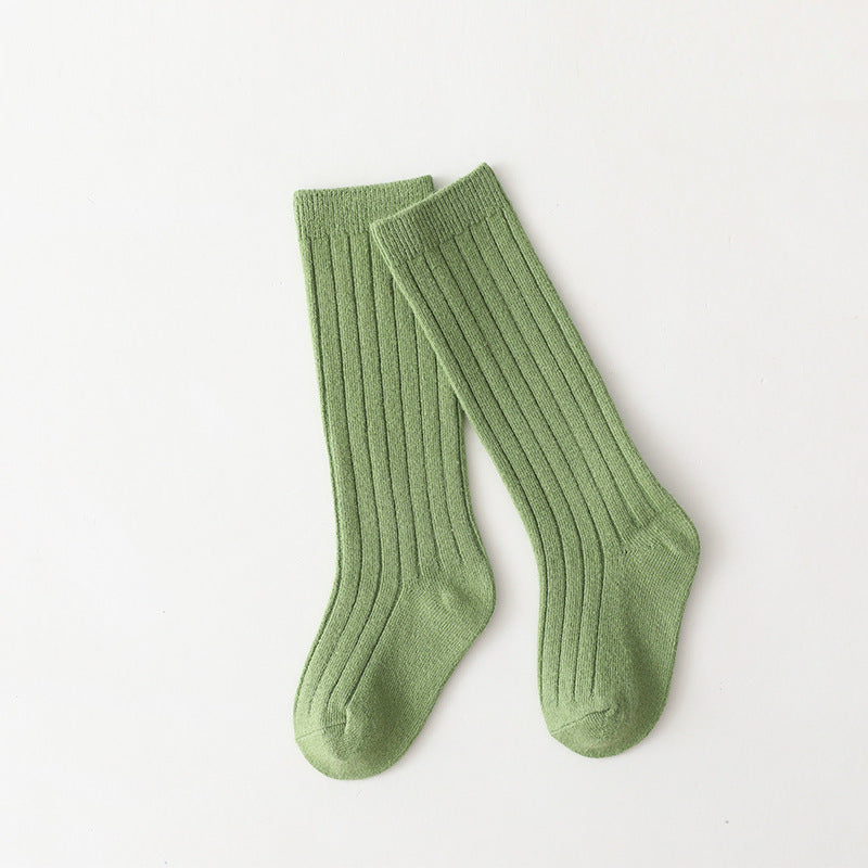 Pair of green mid-calf ribbed baby socks.