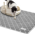 Gray cat litter mat with a diamond grid texture beside a litter box