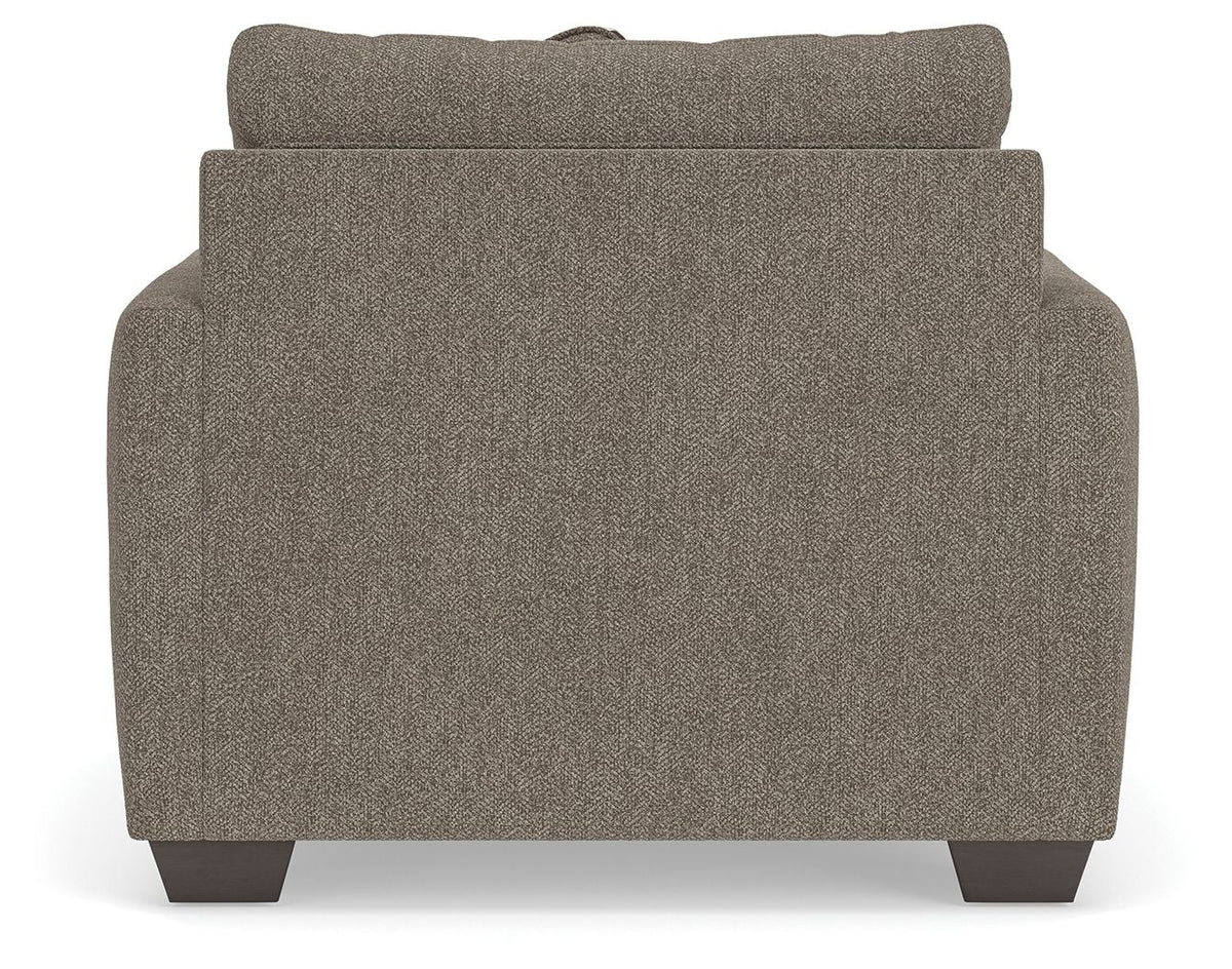 Beige upholstered sofa backrest with textured fabric and curved top edge