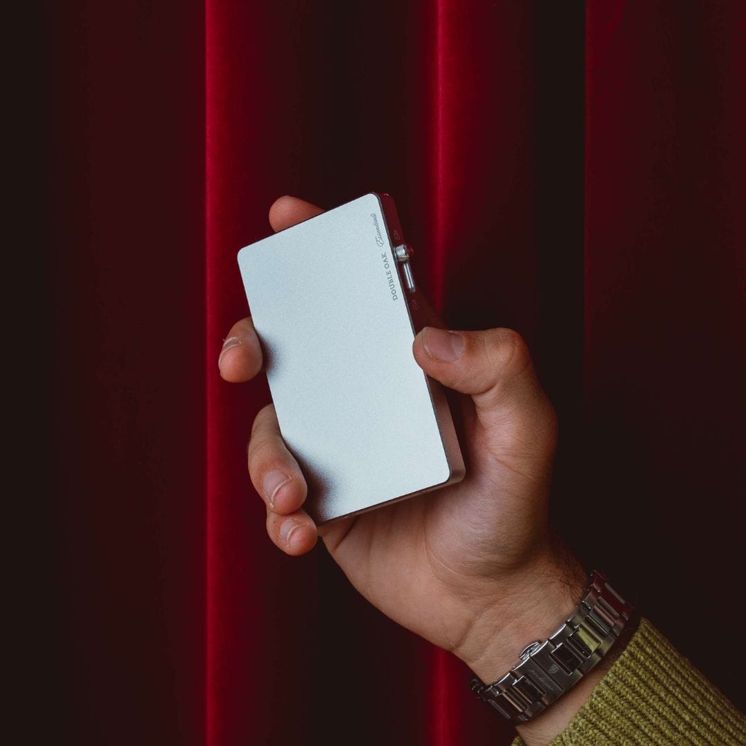 White pop-up cardholder held in hand, smooth front panel.