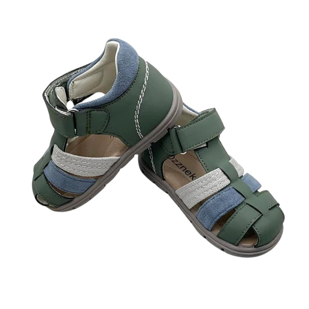 Toddler barefoot sandals side view: dark green upper with blue and gray straps and stitched edges