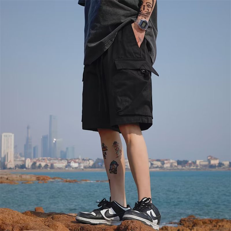 Black cargo capri pants with front pocket flap and utility cargo styling