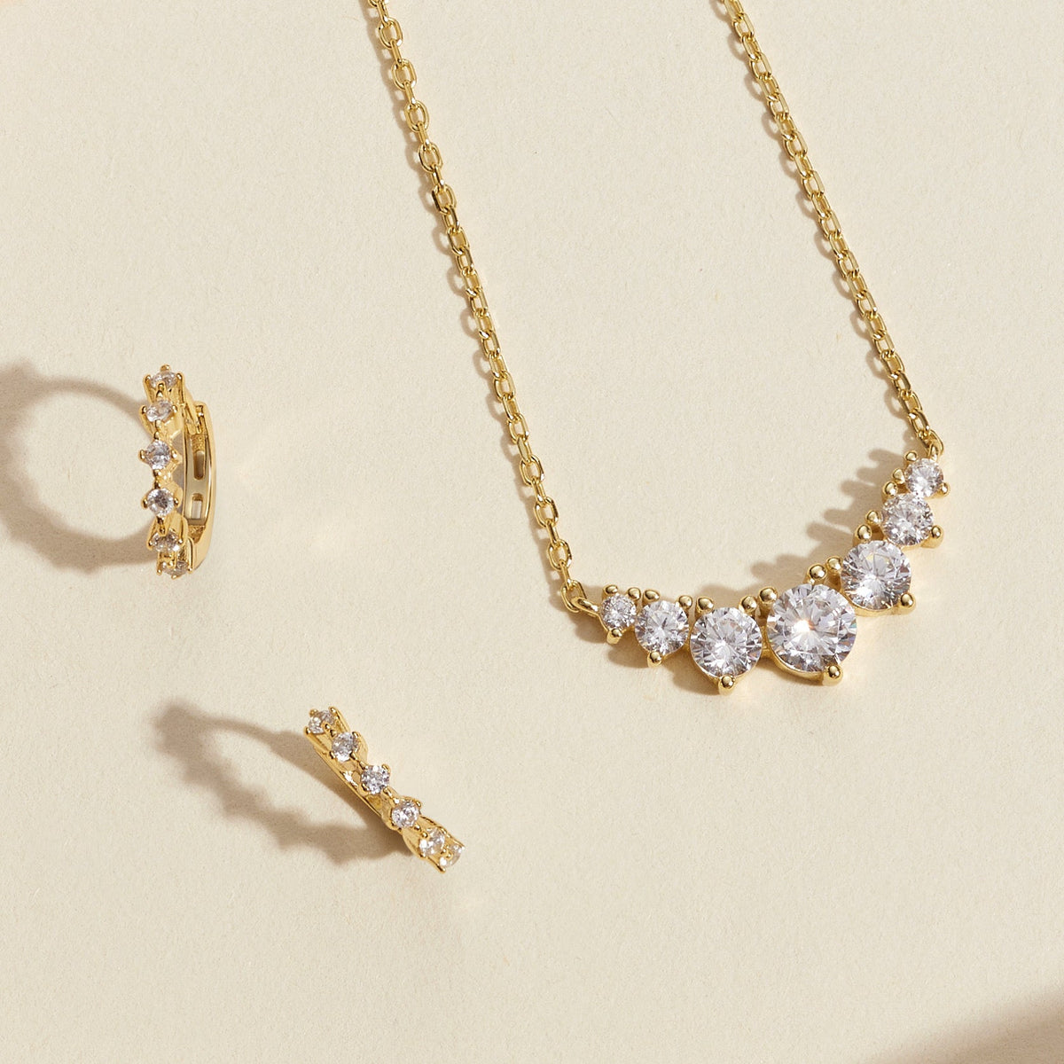 Gold-tone cluster diamond necklace with matching stud and hoop earrings