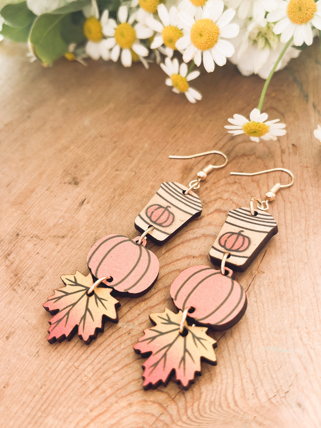 Pair of wood dangling earrings with painted coffee cup, pumpkin, and autumn leaf