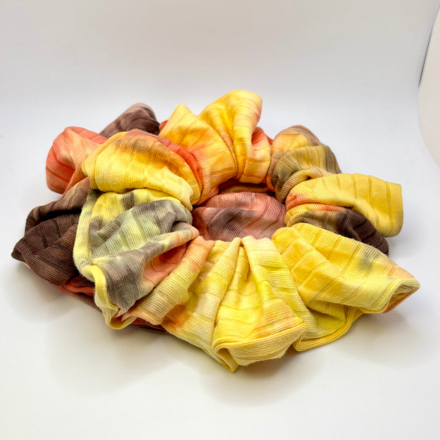 Ribbed tie-dye scrunchie with yellow, orange, and dark brown sections