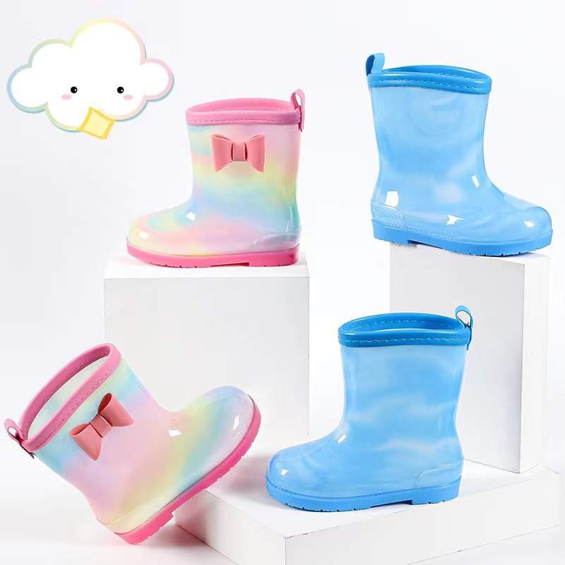 Kids rainbow waterproof rain boots with pink bow, plus light blue matching boots