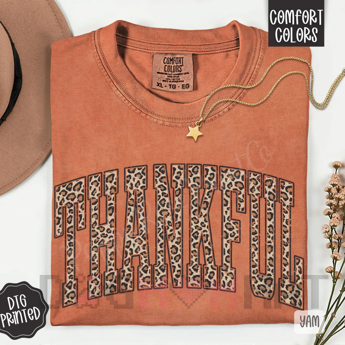 Women’s orange T-shirt with leopard-print “Thankful” graphic and gold star pendant