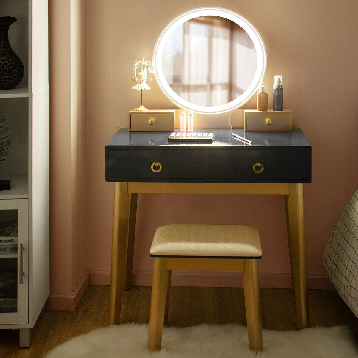 Makeup vanity table set with glowing round mirror, black drawer cabinet, and beige stool
