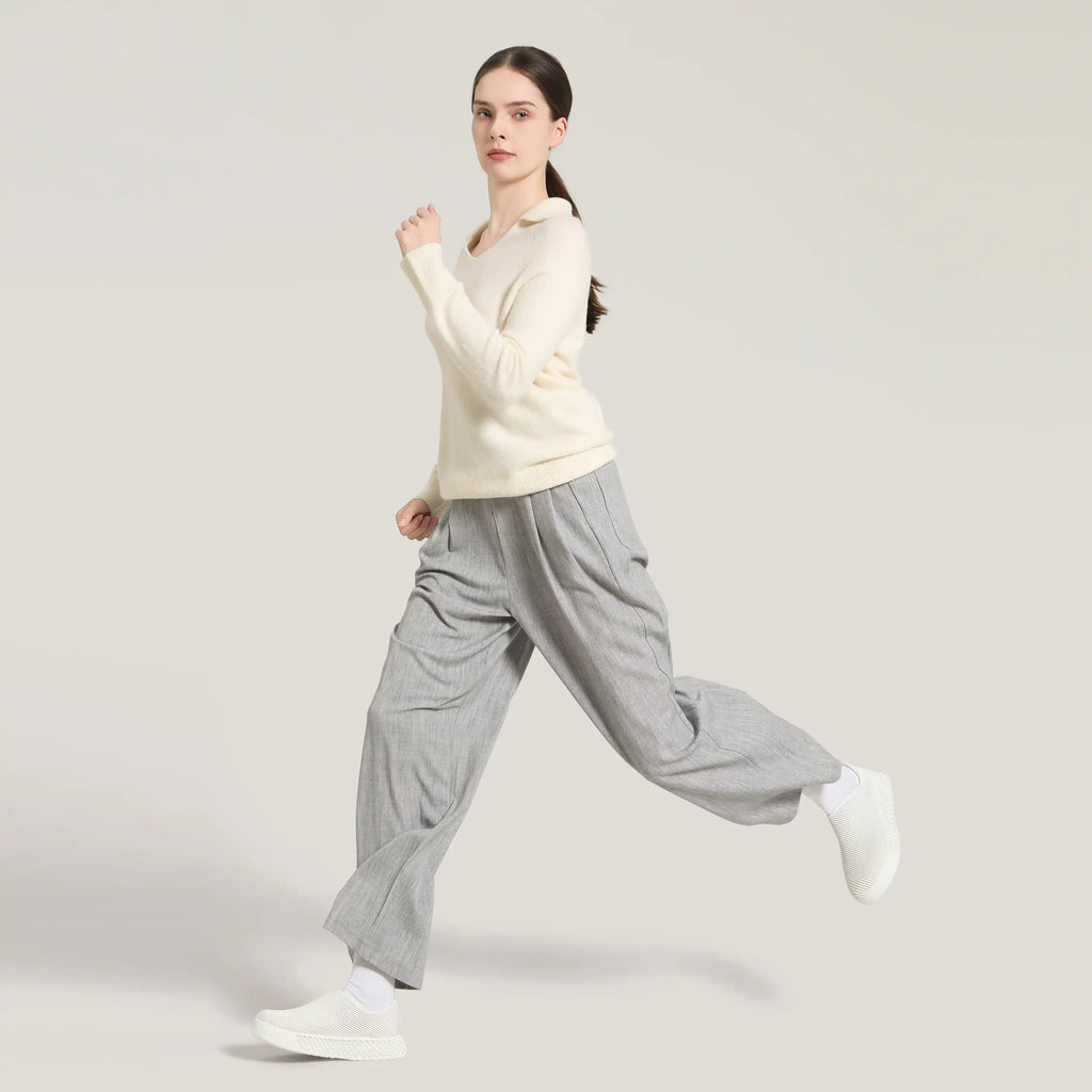 White 3D-printed slip-on sneakers on model with gray pants and white socks