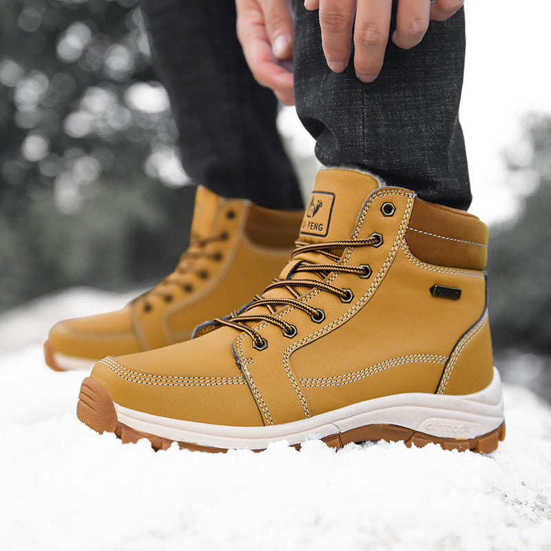 Yellow men's lace-up winter ankle boots with ankle strap and textured outsole in snow