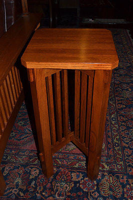 3/4 view of wooden plant stand side table with slatted legs and square top