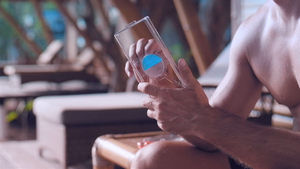 Clear waterproof phone case with lanyard, blue screen visible through the window.