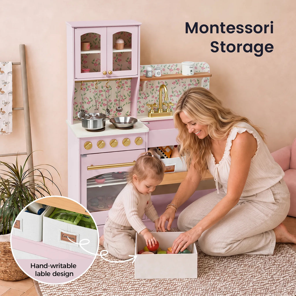 Yellow wooden play kitchen with open shelves and a child playing near the sink area