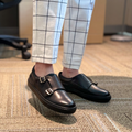 Black slip-on loafers with double buckles and low platform sole