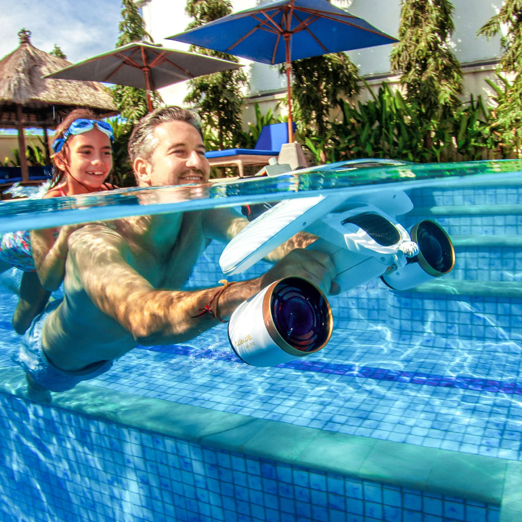 Pool handheld underwater camera with large lens, held near the pool edge