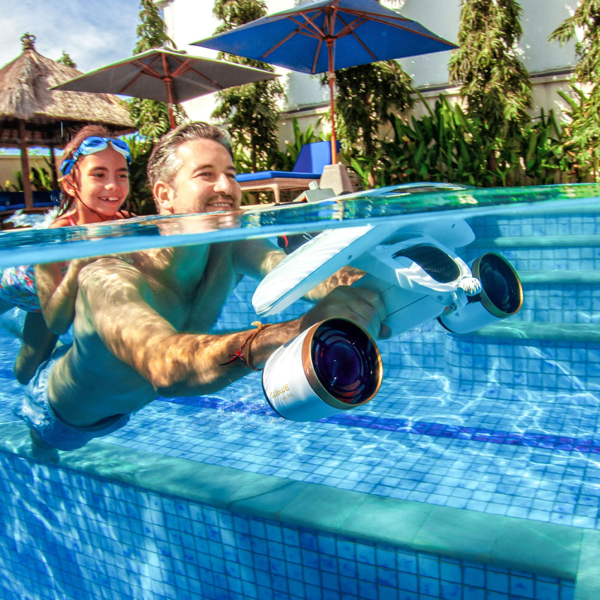 Pool handheld underwater camera with large lens, held near the pool edge