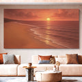 Framed beach wall art in warm sunset tones, with shoreline waves and setting sun