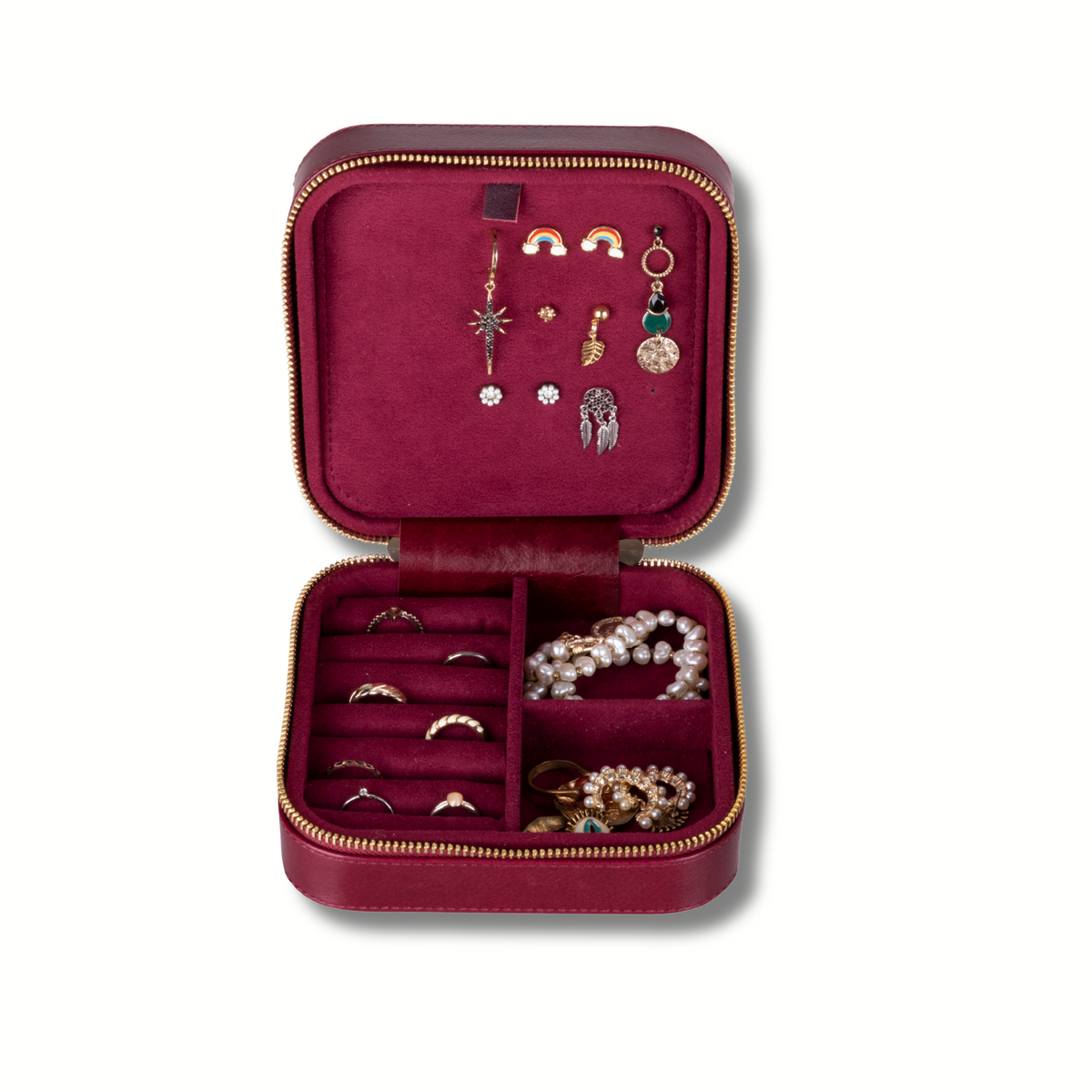 Red velvet travel jewelry box open showing earring hooks and ring slots in gold-trimmed dividers