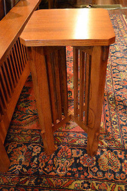 Close view of warm wood spindle plant stand top and side slat panels
