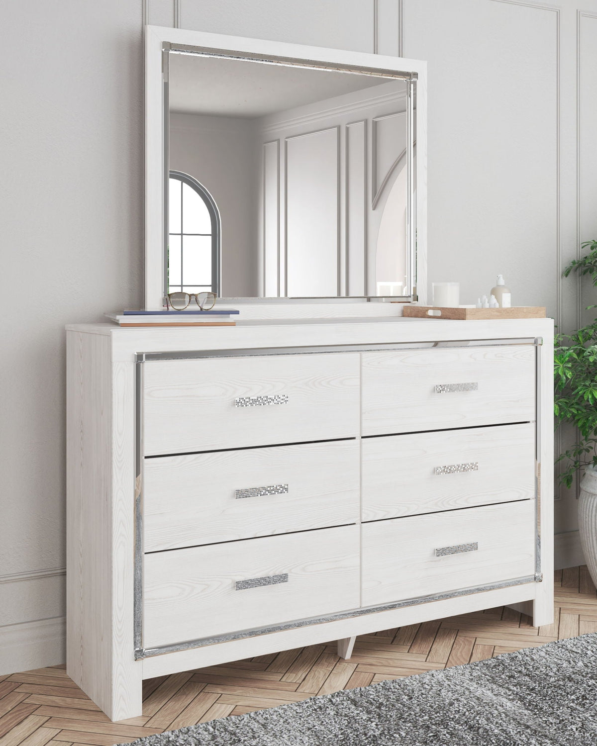 White dresser with attached rectangular mirror and silver drawer pulls