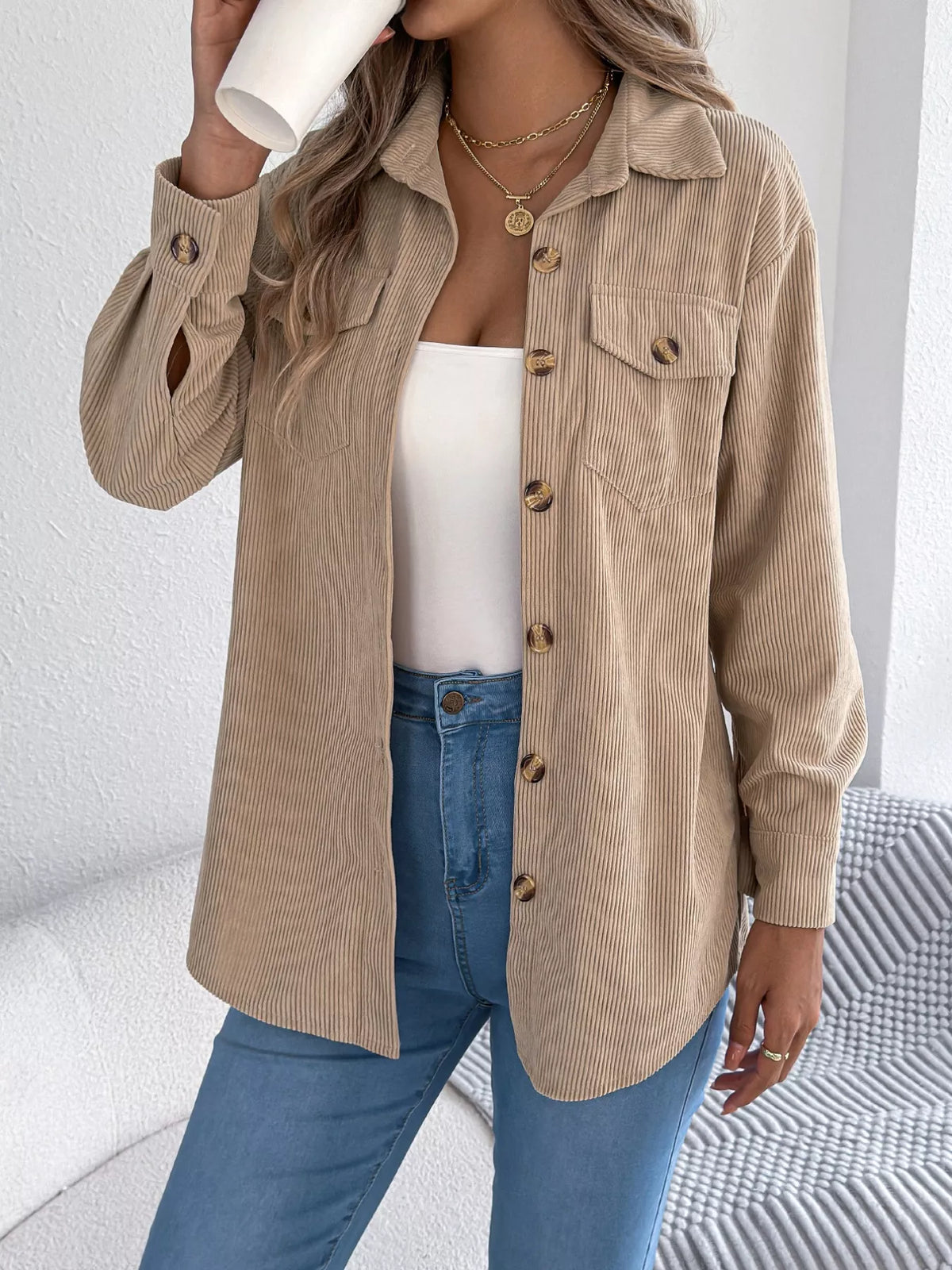 Khaki corduroy button-up shacket with point collar and buttoned chest flap pockets.