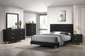 Black upholstered platform bed with tufted headboard, footboard, and gold legs