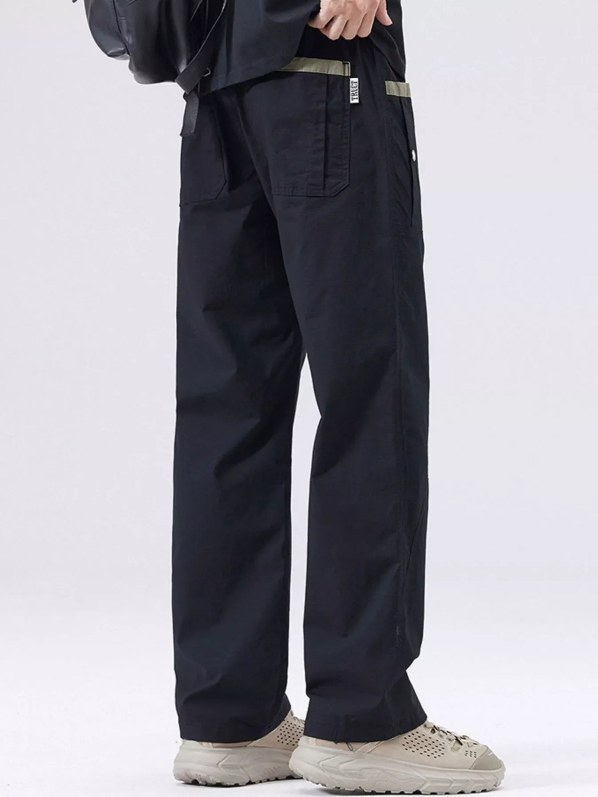 Men's black cargo pants with front pockets and loose straight-leg silhouette.