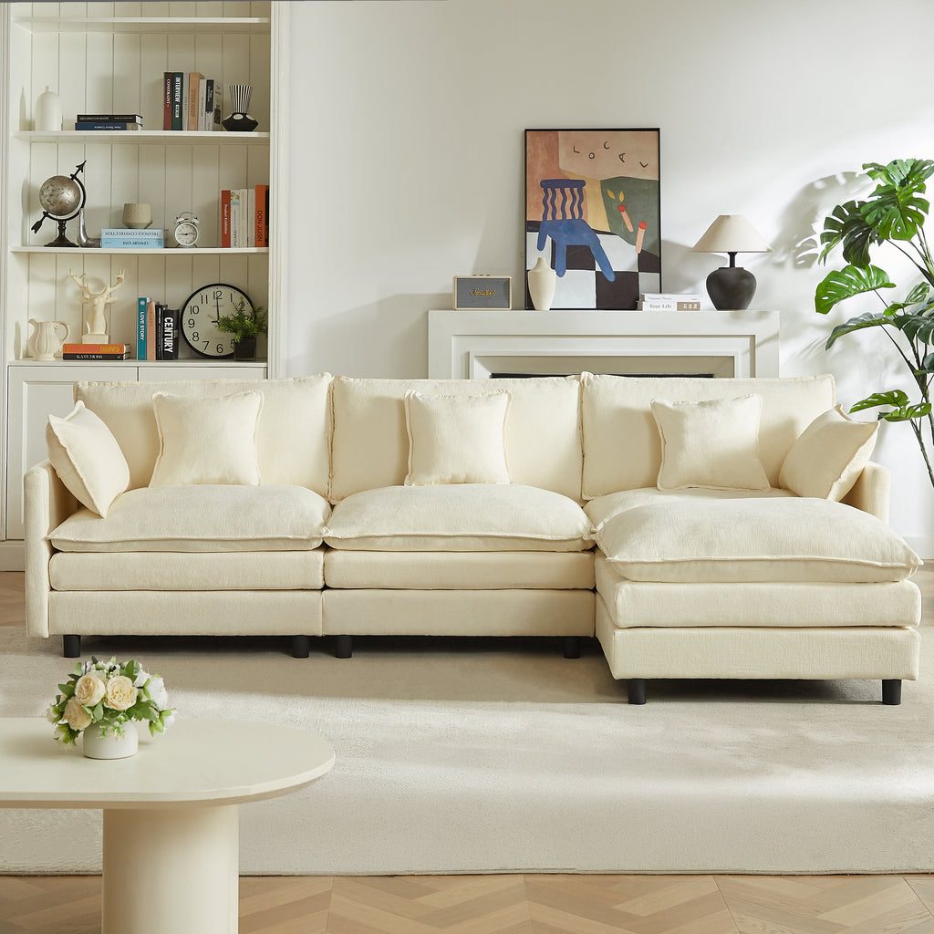 Cream sectional sofa with chaise ottoman and four throw pillows