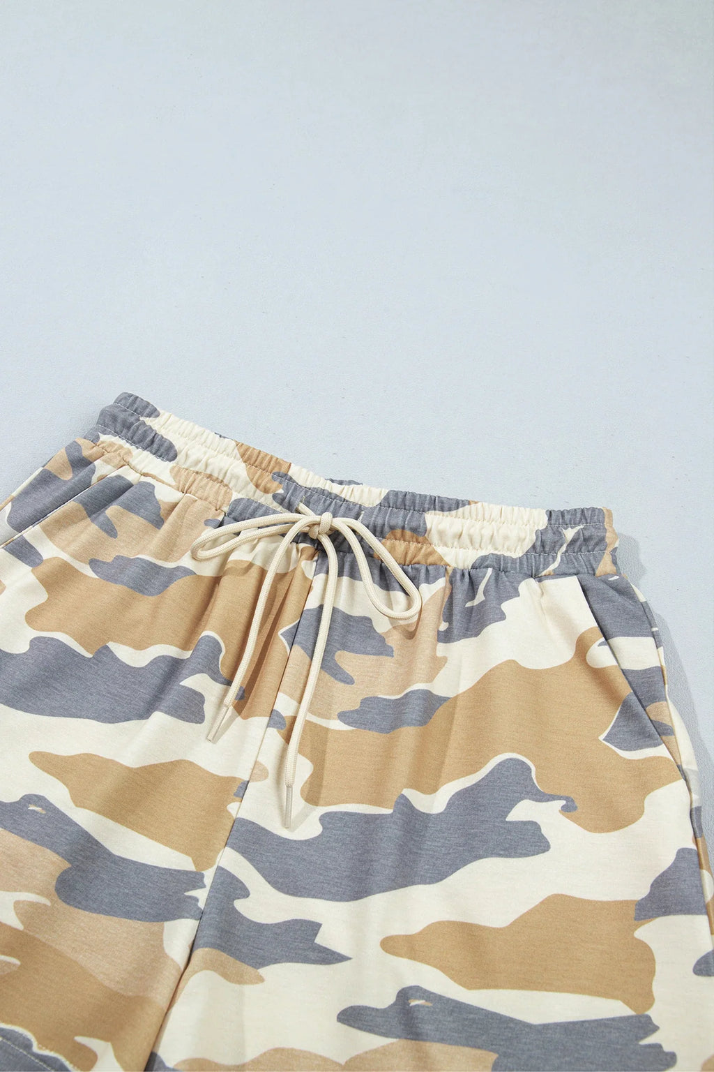 Camo shorts close-up with elastic waistband and drawstring, multicolor